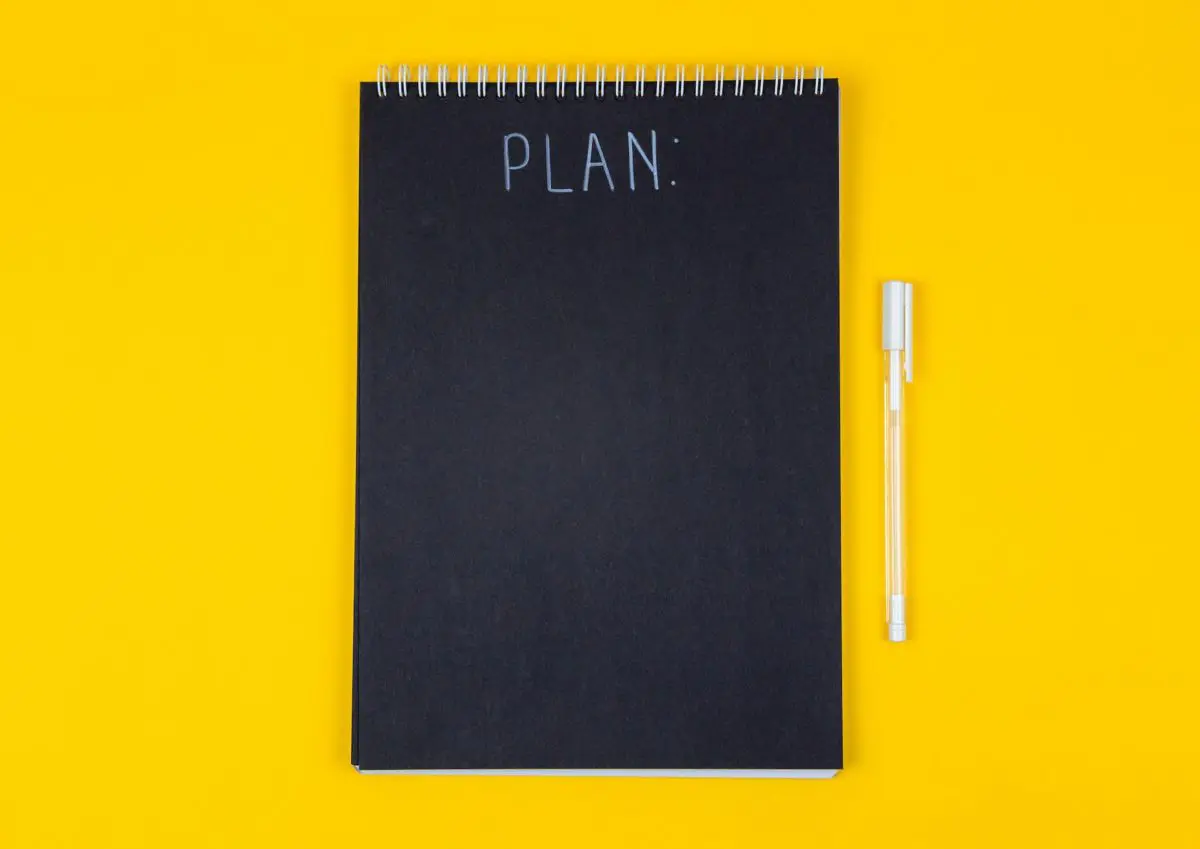Brand management strategies planning in a notepad with Plan written on it